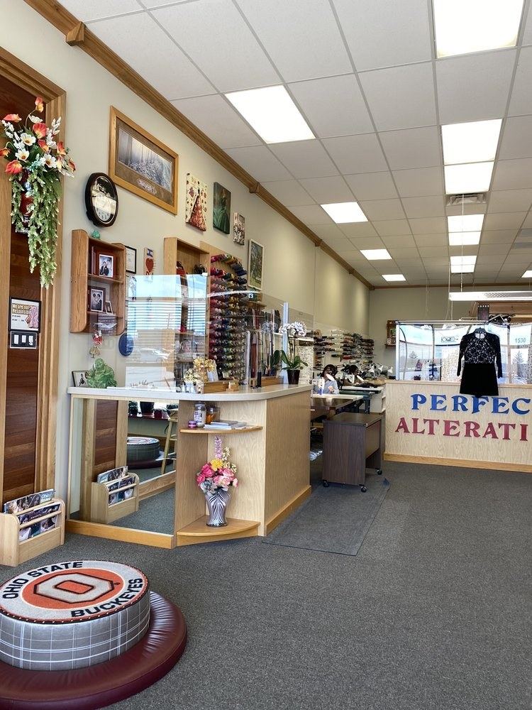 Inside Perfect Alterations: front counter, fitting pedestal and thread wall